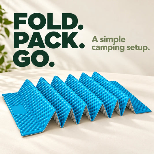 Sky-blue and silver accordion camping mat on a cream tabletop.