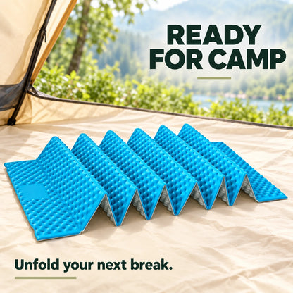 Sky-blue accordion foam mat on a tent floor at a campsite.